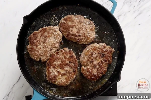 Seared beef patties in a skillet
