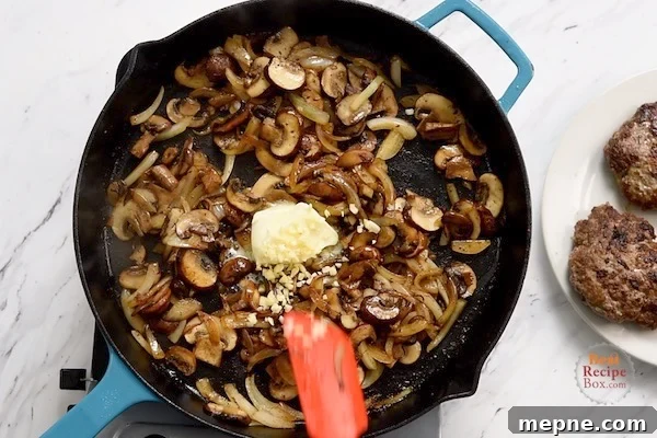 Butter and garlic added to mushrooms and onions