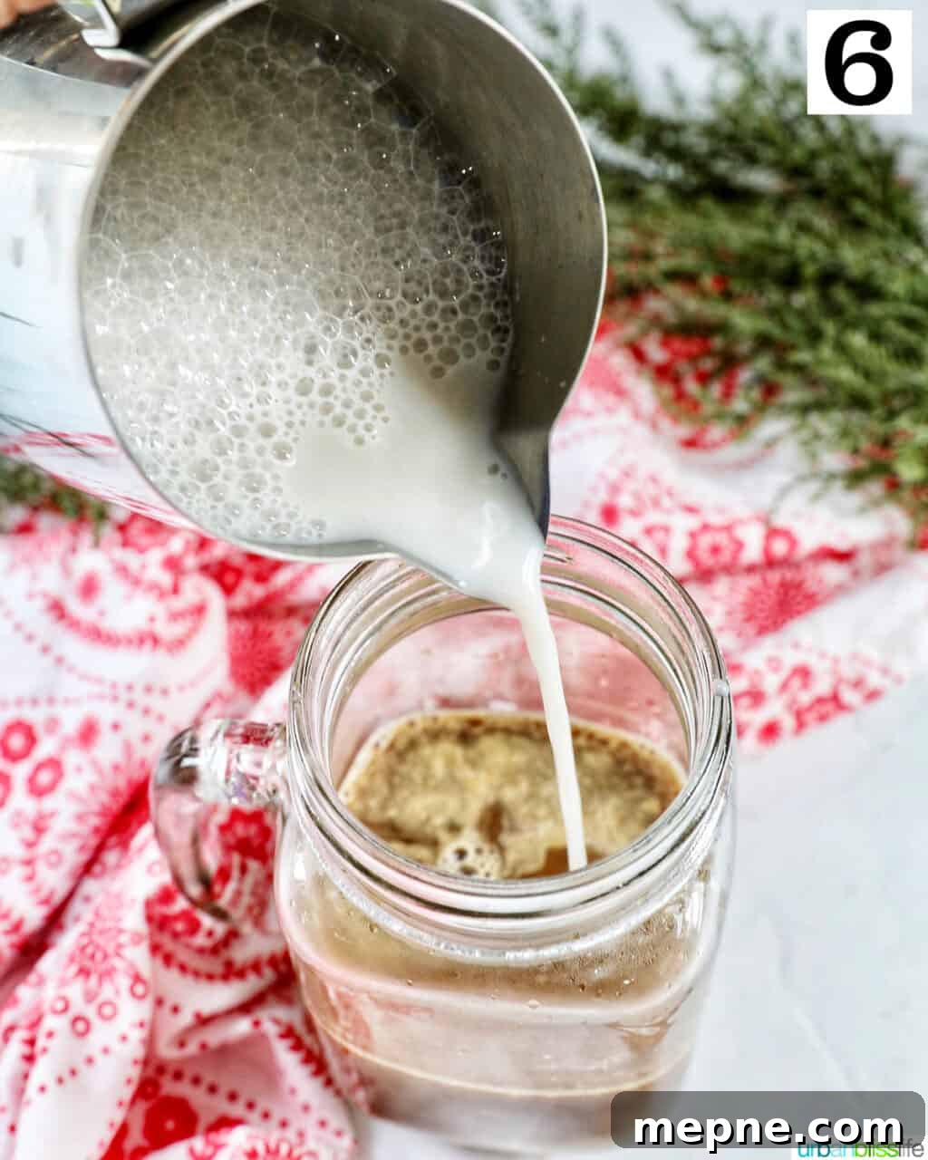White Chocolate Peppermint Mocha Recipe 11 Pouring steamed milk into a mug of white chocolate peppermint mocha.