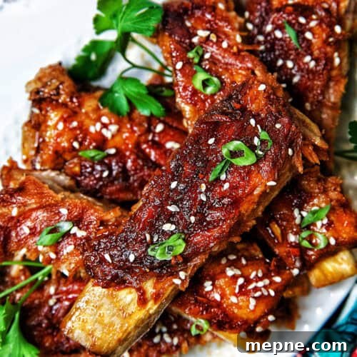 Instant Pot Asian Sticky Pork Ribs on a white plate.