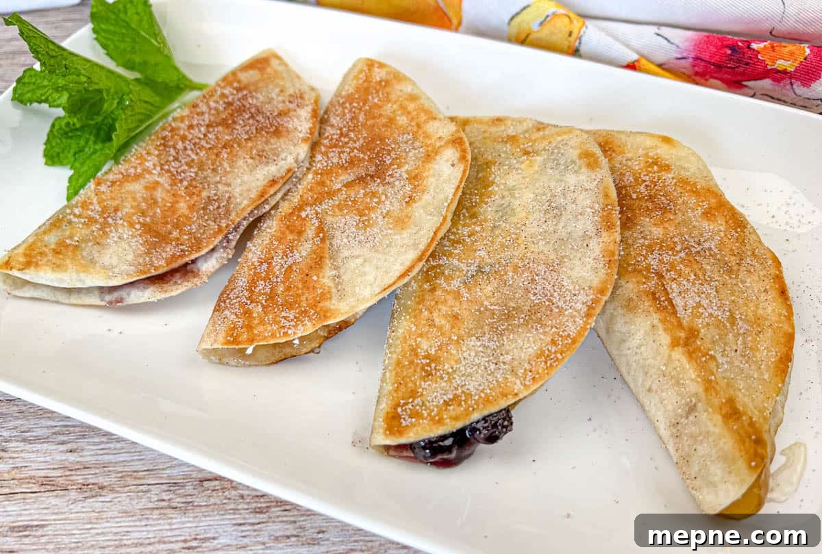 33 BBQ Recipes That Turn Budget Cuts Into Gourmet Meals 22 Four pieces of Fruit Quesadillas on a white plate.