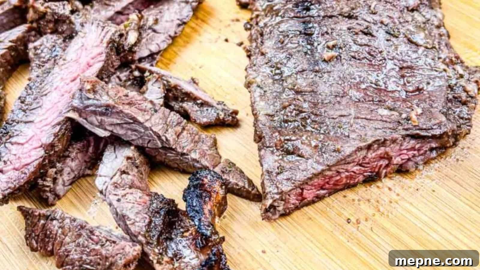 33 BBQ Recipes That Turn Budget Cuts Into Gourmet Meals 24 A sliced and grilled Carne asada on a wooden cutting board.