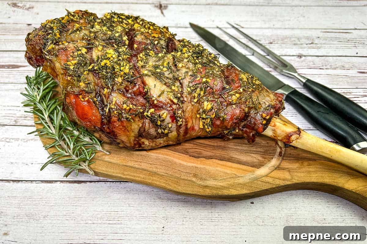 33 BBQ Recipes That Turn Budget Cuts Into Gourmet Meals 32 Whole cooked leg of lamb on a board with a knife.