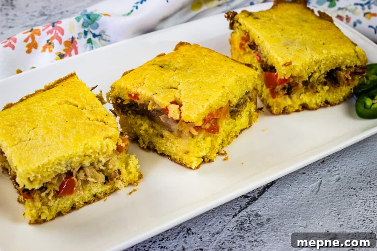 33 BBQ Recipes That Turn Budget Cuts Into Gourmet Meals 33 Three pieces of pulled pork stuffed cornbread on a white rectangular plate.